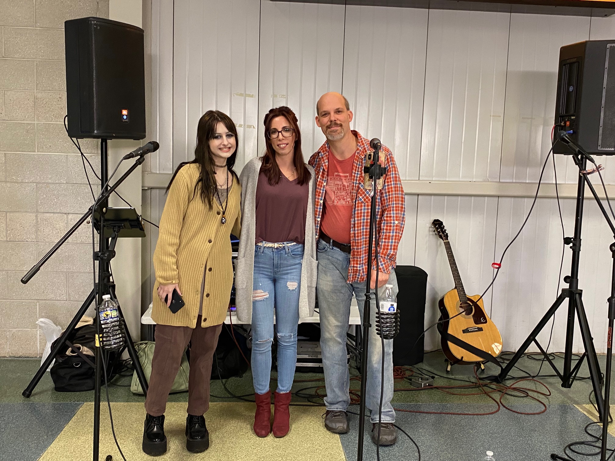 All That Glitters trio posing for a photo at Mohegan Sun Arena, exuding style and charisma as they prepare to entertain the crowd with their sensational music