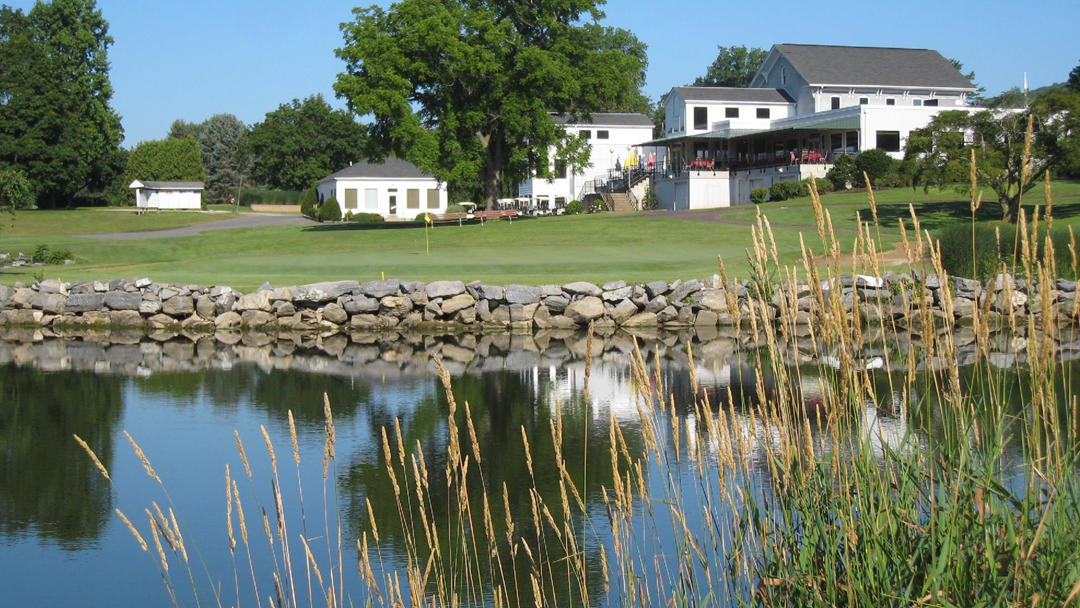Scenic view of Berwick Golf Club exterior with picturesque pond, showcasing the natural beauty of the course